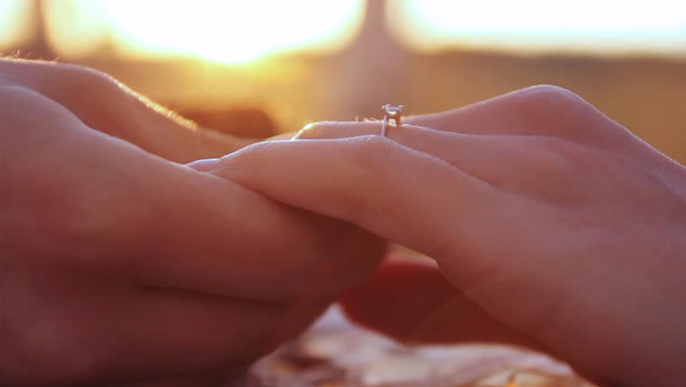 Holding hands after proposing with a ring from Australian Diamond Network